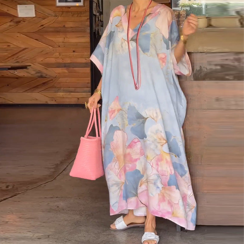 Arenzza floral print loose long dress with half sleeves, featuring a flowing silhouette and vibrant floral pattern.