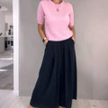 A woman wearing a beige knit top and loose wide-leg pants set from Arenzza, showcasing casual, comfortable clothing ensemble.