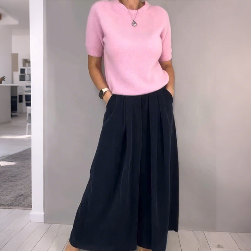 A woman wearing a beige knit top and loose wide-leg pants set from Arenzza, showcasing casual, comfortable clothing ensemble.