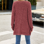 A woman wearing a soft knit oversized tunic sweater by Arenzza, featuring a cozy, relaxed fit in a neutral color.