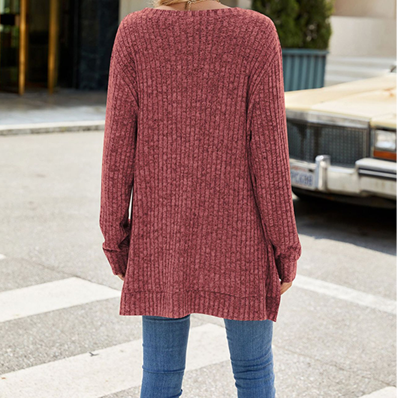 A woman wearing a soft knit oversized tunic sweater by Arenzza, featuring a cozy, relaxed fit in a neutral color.