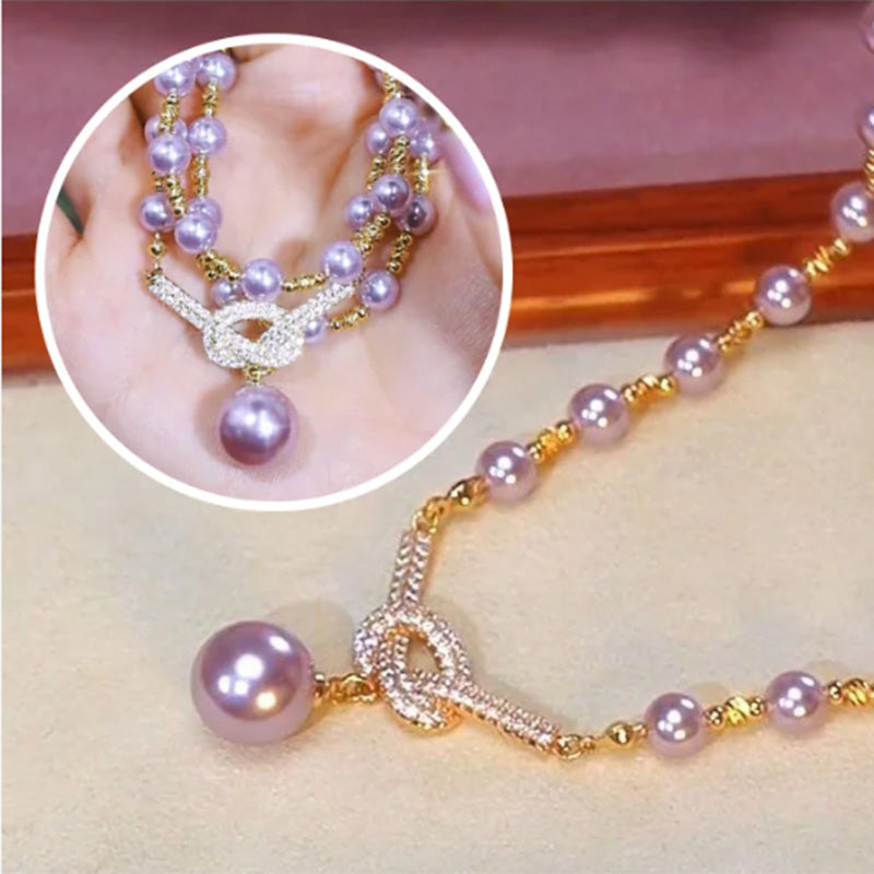 A women's pearl necklace from Arenzza featuring white pearls and a delicate clasp, displayed on a neutral background.