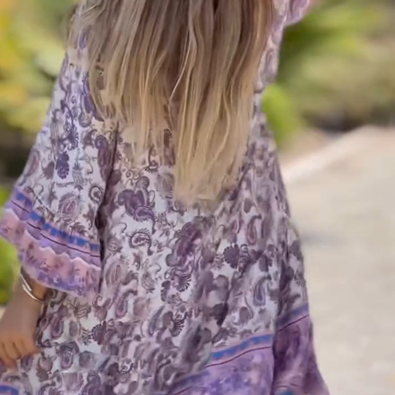 Women’s floral V-neck dress by Arenzza featuring a vibrant, lightweight fabric with a fitted waist and flowing skirt.