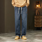 Men's loose straight jeans by Arenzza, shown in dark denim with classic five-pocket design and relaxed fit.