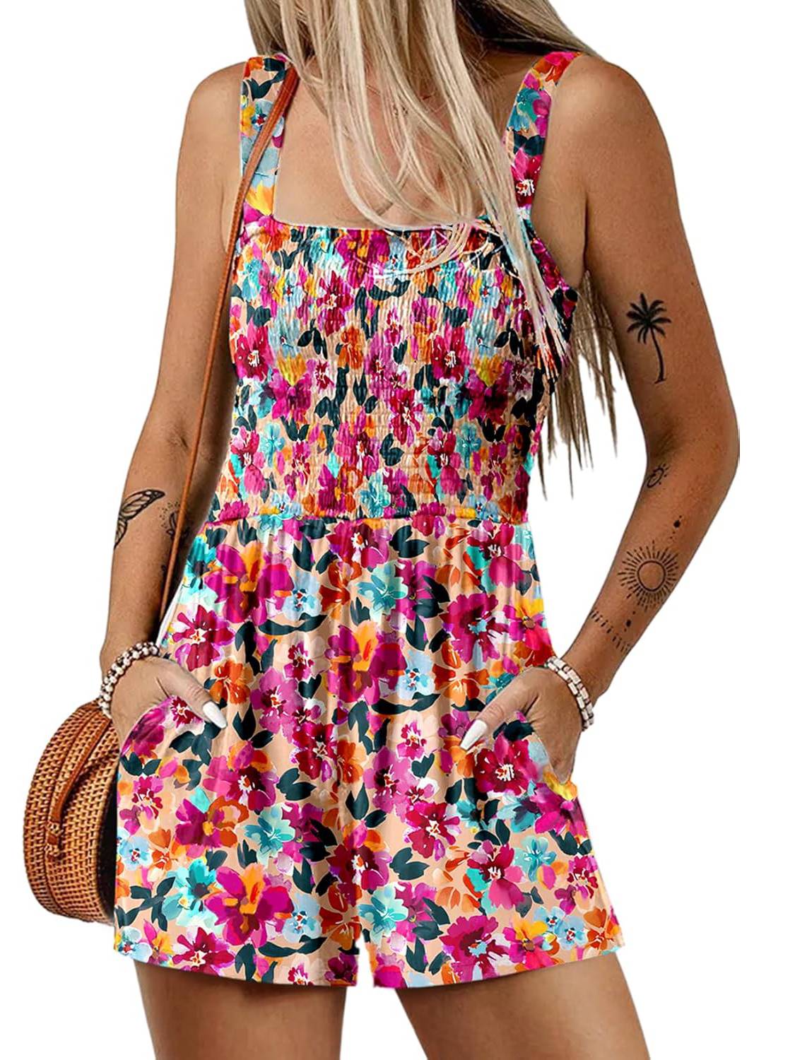 A woman wearing a sleeveless, loose summer romper with a square neckline and smocked waist, in a casual style by Arenzza.
