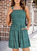 A woman wearing a sleeveless, square neck, loose casual romper by Arenzza, featuring smocked details and a summer style.
