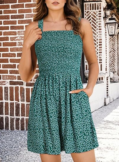 A woman wearing a sleeveless, square neck, loose casual romper by Arenzza, featuring smocked details and a summer style.