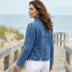A blue denim open-front jacket with ruffle trim, breathable fabric, from Arenzza, styled as a versatile wardrobe staple.