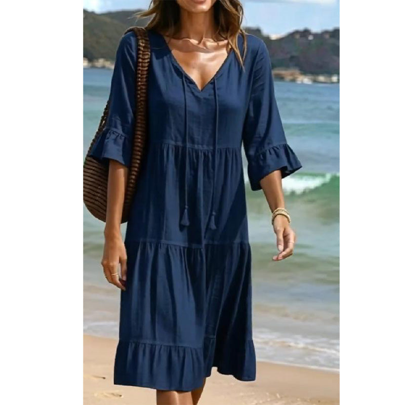 A women's V-neck tassel tie tiered midi dress by Arenzza, featuring a flowy silhouette and layered fabric in a stylish design.