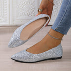 A pair of women's glitter pointed toe flats by Arenzza, showcasing shiny, stylish footwear on a neutral background.