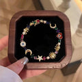 Arenzza celestial charm bracelet with star and moon designs, featuring silver-tone metal and a secure clasp, on a white background.