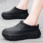 A pair of stylish Arenzza non-slip closed toe clogs with a sleek design, perfect for comfortable, everyday wear.