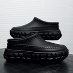 A pair of stylish Arenzza non-slip closed toe clogs with a sleek design, perfect for comfortable, practical footwear.