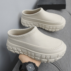 A pair of stylish Arenzza non-slip closed toe clogs with a sleek design, perfect for comfortable, everyday wear.