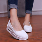 A pair of women's breathable nursing shoes from Arenzza, showcasing comfortable slip-on design and breathable fabric in neutral color.