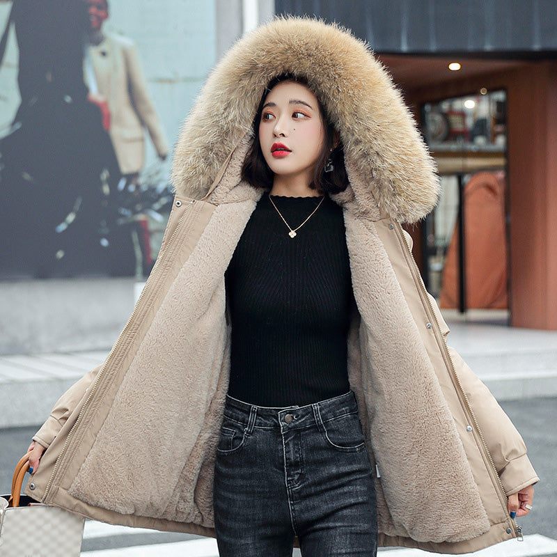 A woman wearing a thick, loose hooded fleece winter parka coat by Arenzza, designed for warmth and comfort in cold weather.
