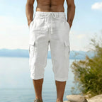 A pair of men's linen blend cargo capri pants by Arenzza, displayed flat with pockets and a relaxed fit, in neutral color.