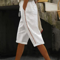 A pair of Arenzza women's summer capri pants with lace cutout details, lightweight fabric, and a relaxed fit.