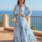 A woman wearing an elegant floral pleated maxi dress with a V-neck, stylishly flowing in a natural pose, by Arenzza.