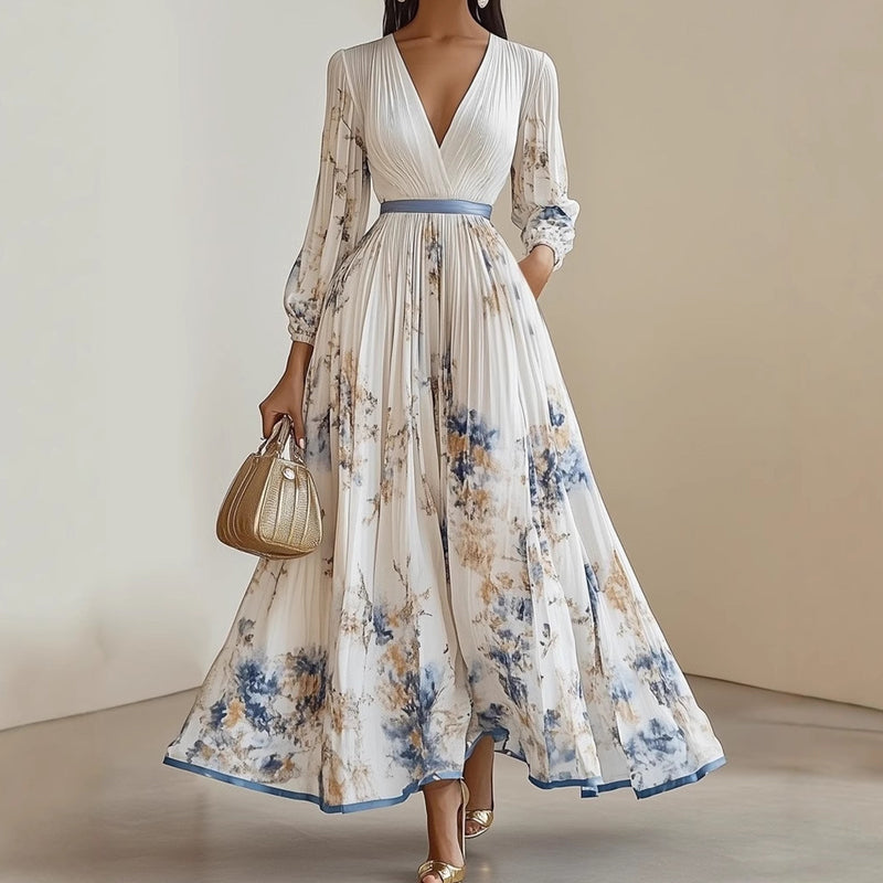 A woman wearing an elegant V-neck floral pleated maxi dress by Arenzza, showcasing a flowing design with vibrant floral patterns.