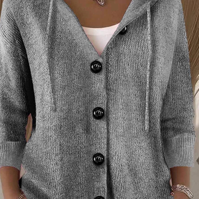 Aarenza women's solid color long sleeve cardigan in a cozy knit fabric, displayed on a hanger in a neutral tone.