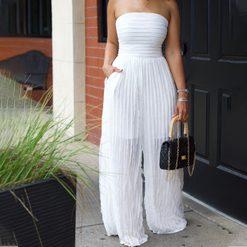 A beige strapless crinkle wide-leg jumpsuit from Arenzza displayed on a hanger, showcasing its flowy fabric and relaxed fit.
