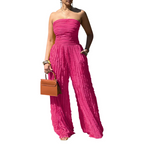 A woman wearing a strapless crinkle wide-leg jumpsuit by Arenzza, showcasing its relaxed fit and stylish design.