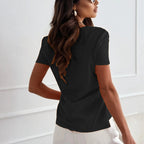 A woman wearing a solid V-neck short sleeve top from Arenzza, showcasing a casual, fitted women's clothing style.