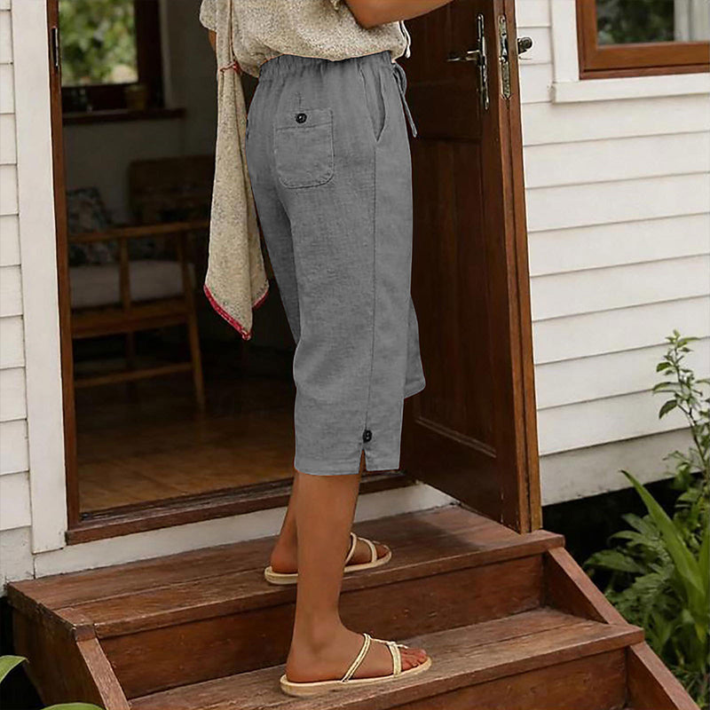 A pair of women's cropped casual pants by Arenzza featuring button details, displayed on a neutral background.
