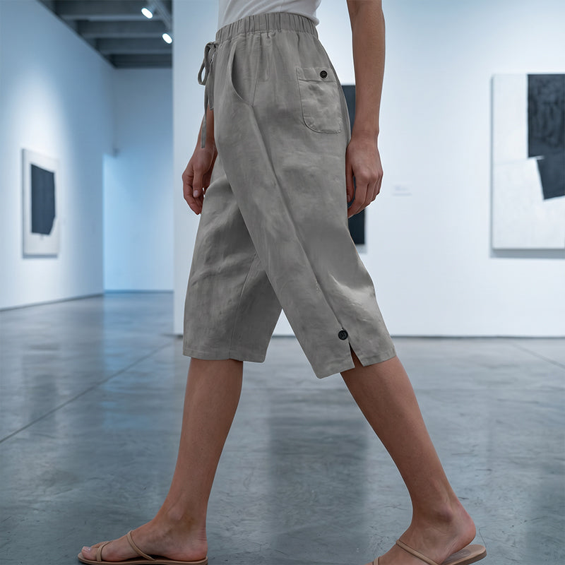 A woman wearing Arenzza women's casual cropped pants with button detail, styled casually with a relaxed fit.