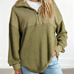 A woman wearing a light gray Women’s casual solid color half-zip sweatshirt by Arenzza, featuring a relaxed fit and soft fabric.
