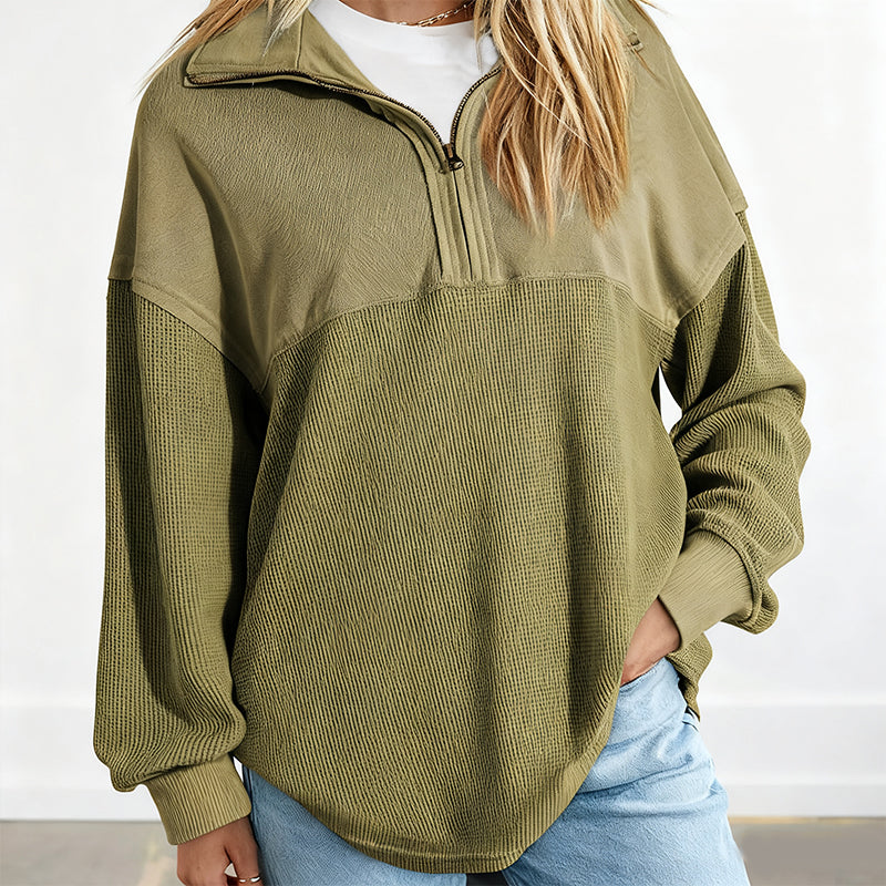 A woman wearing a light gray Women’s casual solid color half-zip sweatshirt by Arenzza, featuring a relaxed fit and soft fabric.