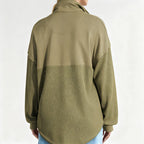 A woman wearing an Arenzza women's casual solid color half-zip sweatshirt, showcasing its relaxed fit and soft fabric.