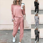 A woman wearing a solid color casual long sleeve top and drawstring pants from Arenzza, showcasing a relaxed, comfortable clothing set.