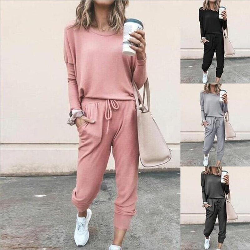 A woman wearing a solid color casual long sleeve top and drawstring pants from Arenzza, showcasing a relaxed, comfortable clothing set.