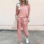 A woman wearing a solid color casual long sleeve top and drawstring pants from Arenzza, showcasing a comfortable loungewear set.