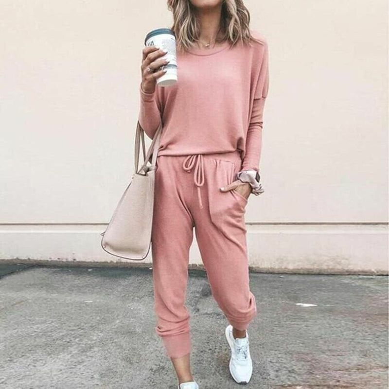 A woman wearing a solid color casual long sleeve top and drawstring pants from Arenzza, showcasing a comfortable loungewear set.