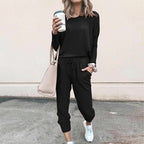 Women’s solid color casual set by Arenzza featuring a long sleeve top and drawstring pants, perfect for comfortable everyday wear.