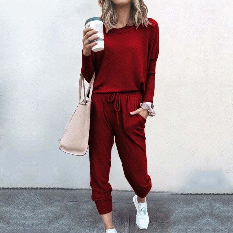 A women’s solid color casual set by Arenzza featuring a long sleeve top and drawstring pants, perfect for comfortable everyday wear.
