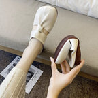 A pair of women's Arenzza soft sole knot mules with a stylish design, beige color, and slip-on style.