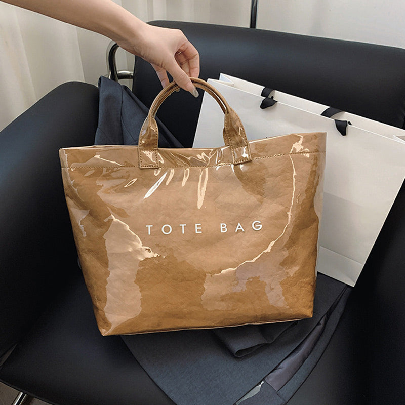 Women's Arenzza retro tote bag with colorful letters print, made of durable fabric, featuring sturdy handles and spacious interior.