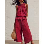 A woman wearing a sleeveless smocked neck top and matching pants set by Arenzza, stylish trendy clothing for women.