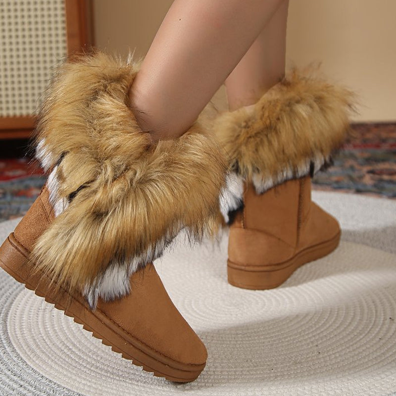 A pair of women's slip-on plush snow ankle booties by Arenzza, featuring soft fabric and cozy winter footwear style.