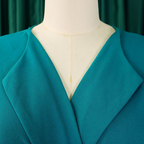 A woman wearing an elegant V-neck pleated dress with belt by Arenzza, showcasing the stylish design and flowing fabric.
