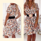 A woman wearing a floral print V-neck mini dress by Arenzza, perfect for summer, with a bright, cheerful floral pattern.