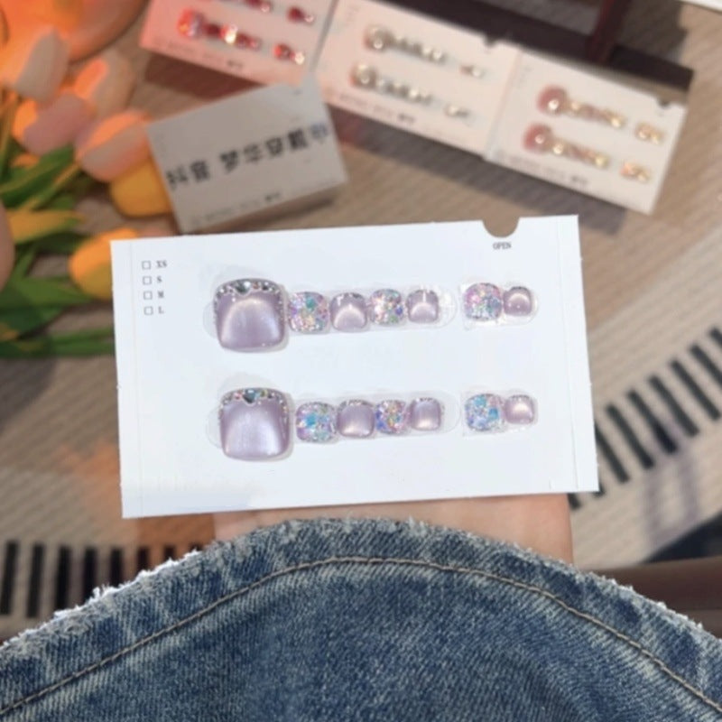 A set of 14 square press-on toenails from Arenzza, arranged neatly in a cosmetic display, ready for application.
