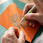 A person using the ProCraft™ Arenzza cutting tool for artistic projects in a creative workspace.