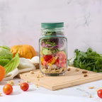Aarenza SmartMix™ green vegetable keeper with a clear lid, designed to keep greens fresh and crisp in the refrigerator.