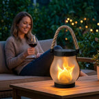Aarenza EverFlame Solar Lantern illuminating a cozy outdoor patio with a warm, flickering flame at dusk.