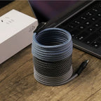 Arenzza magnetic auto storage fast charging cable connected to a vehicle's electronic device in a car interior.